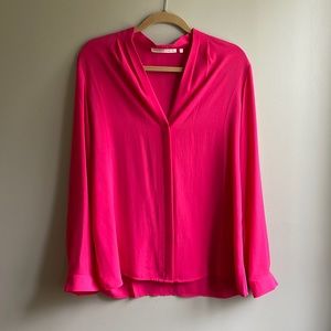 Beautiful pink rayon blouse with a streamline look and hidden buttons.